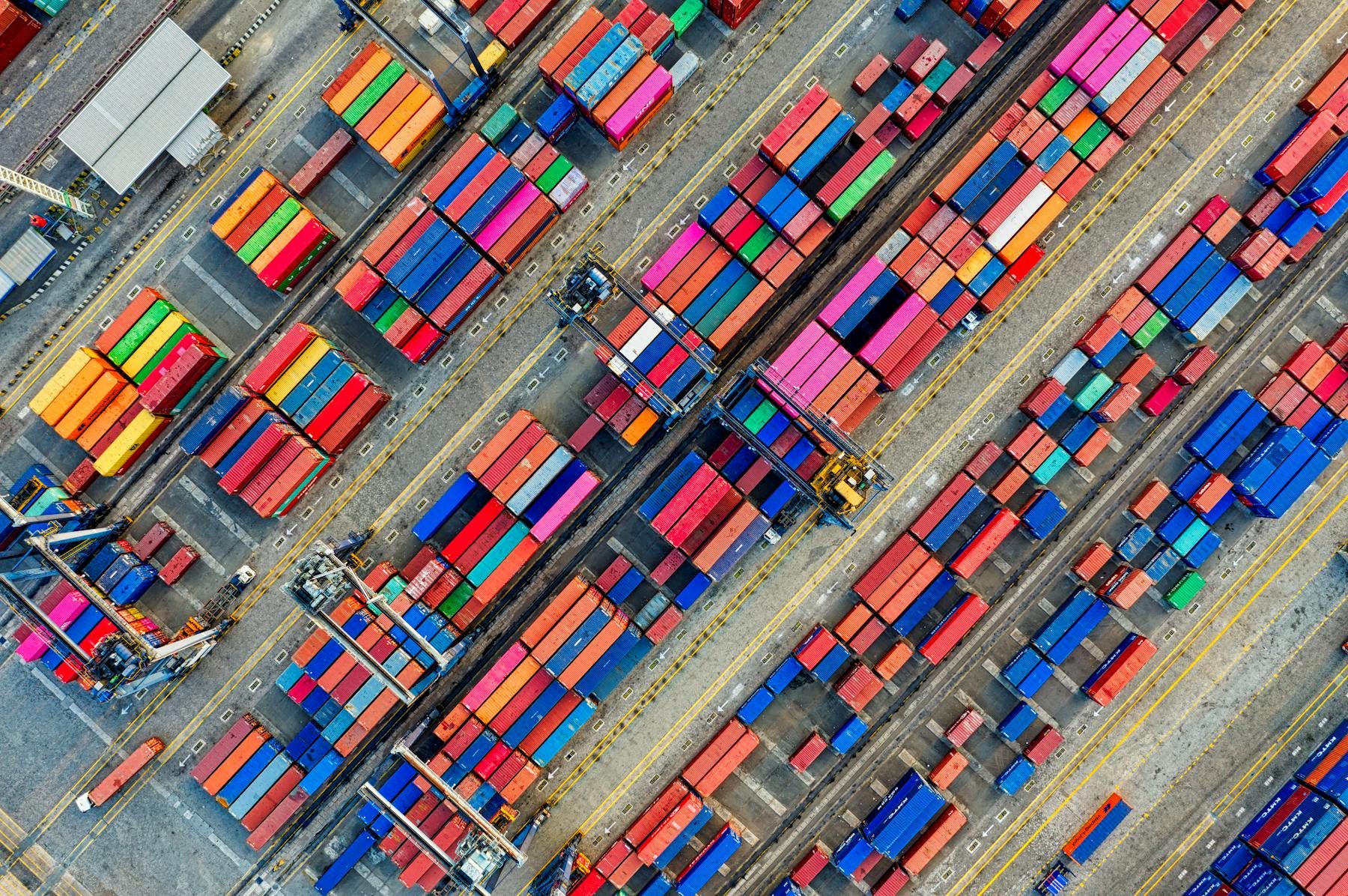 Aerial view of a container yard with tightly organized shipping containers.